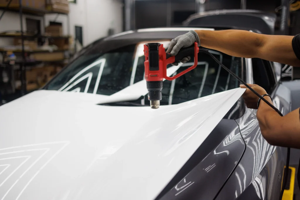 Car finished with color paint protection film showing vivid wrap-style color change with underlying chip protection